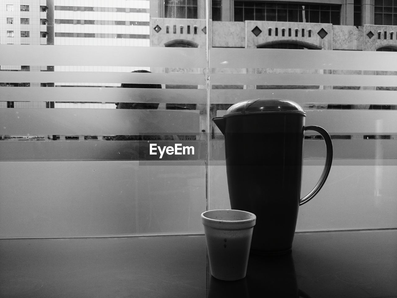 CLOSE-UP OF COFFEE IN GLASS ON TABLE