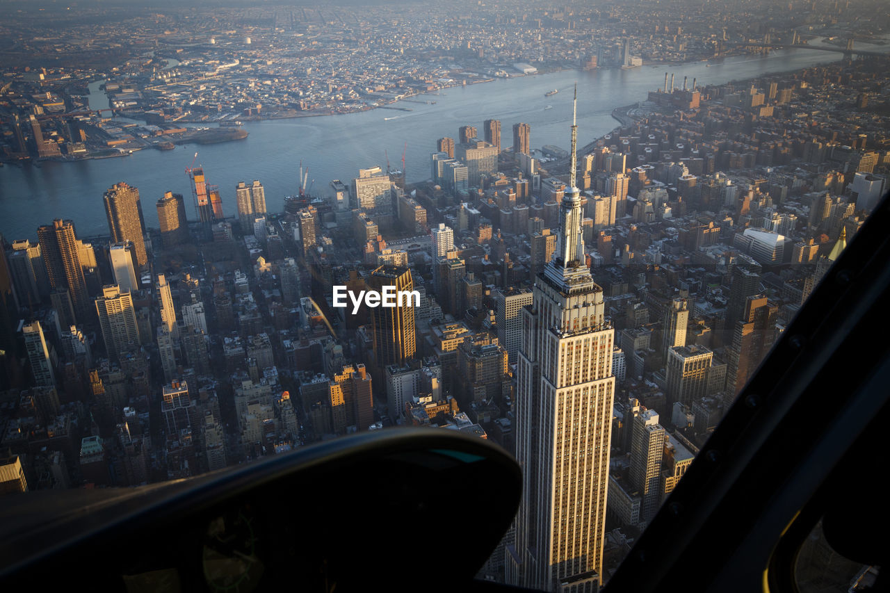 An aerial helicopter view of the empire state building in new york.