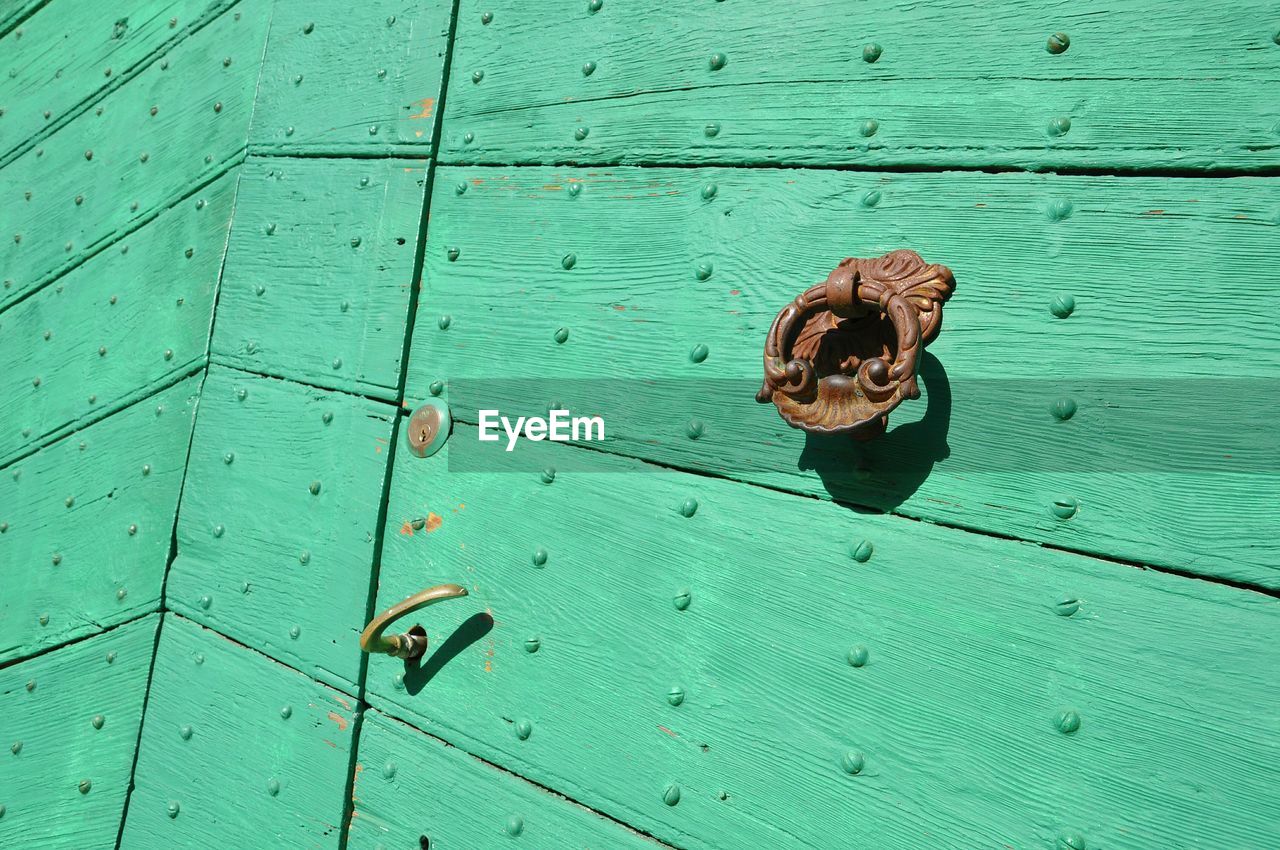 High angle view of metal door on wood