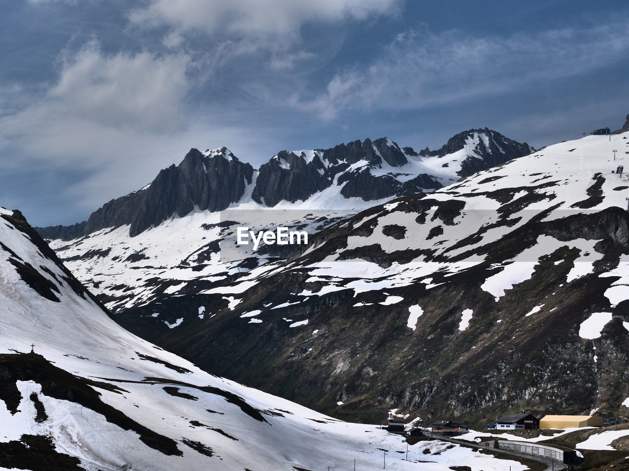 Scenic view of snow covered mountains against sky