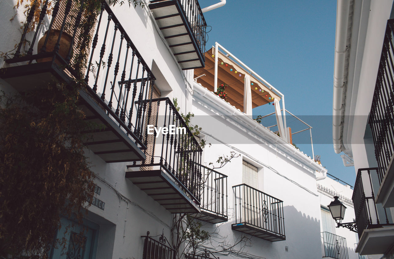 Low angle view of staircase by building against sky