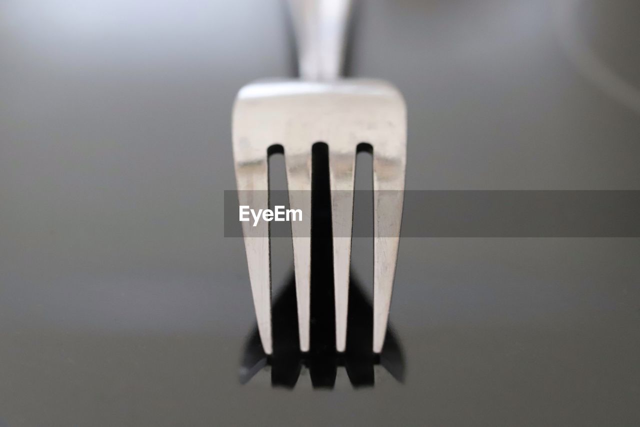 Closeup image of metal fork casting reflection