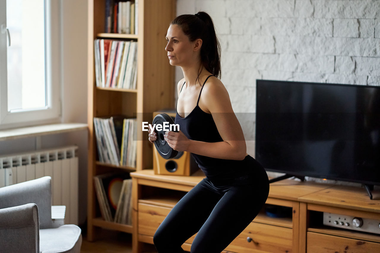 Young woman doing sports and yoga at home. high quality photo