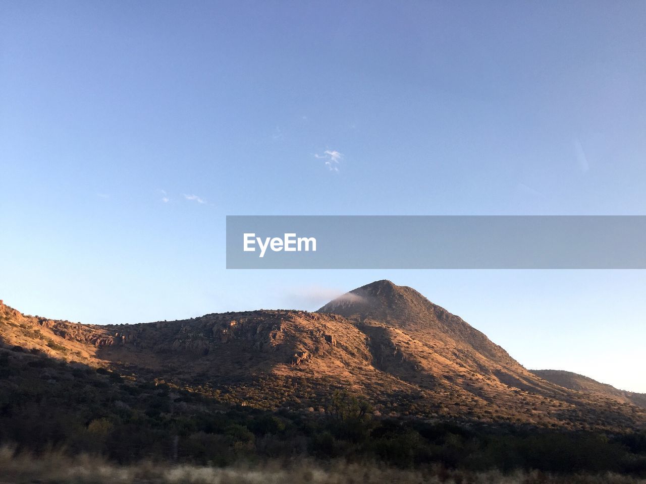 View of mountain range against blue sky