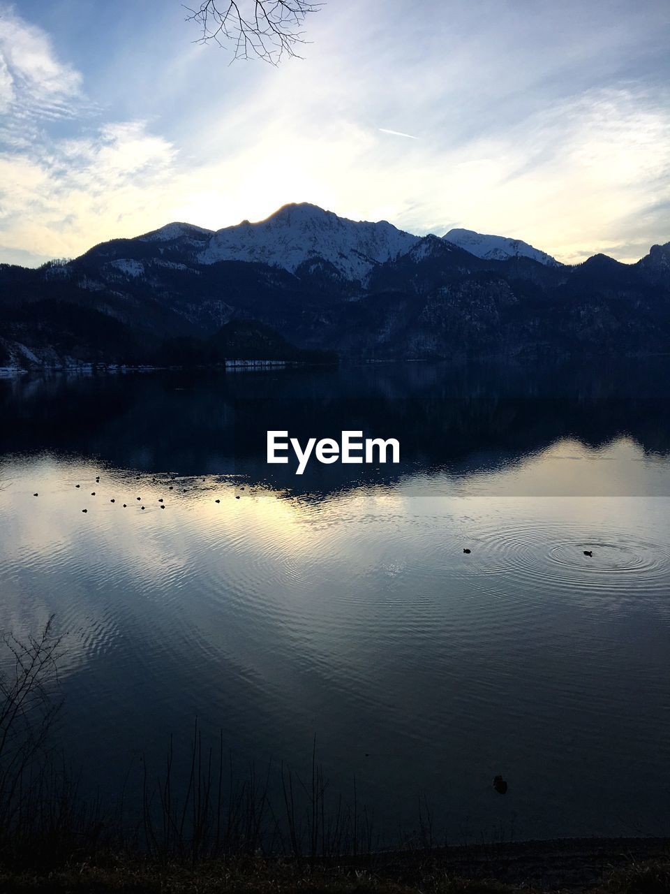 Scenic view of lake by mountains against sky