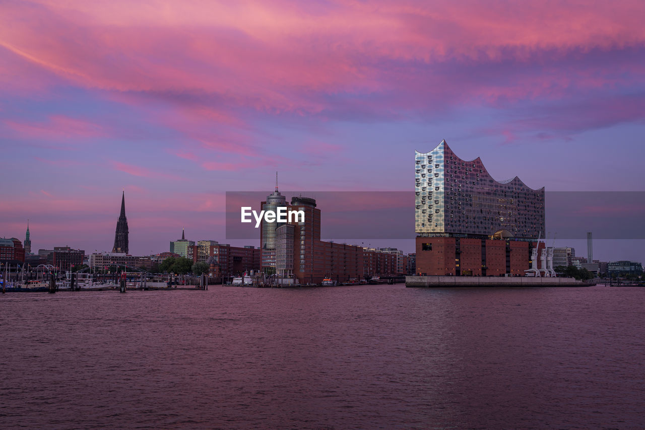 A colorful sunset from hamburg waterfront in germany with the elbphilharmonie building in front