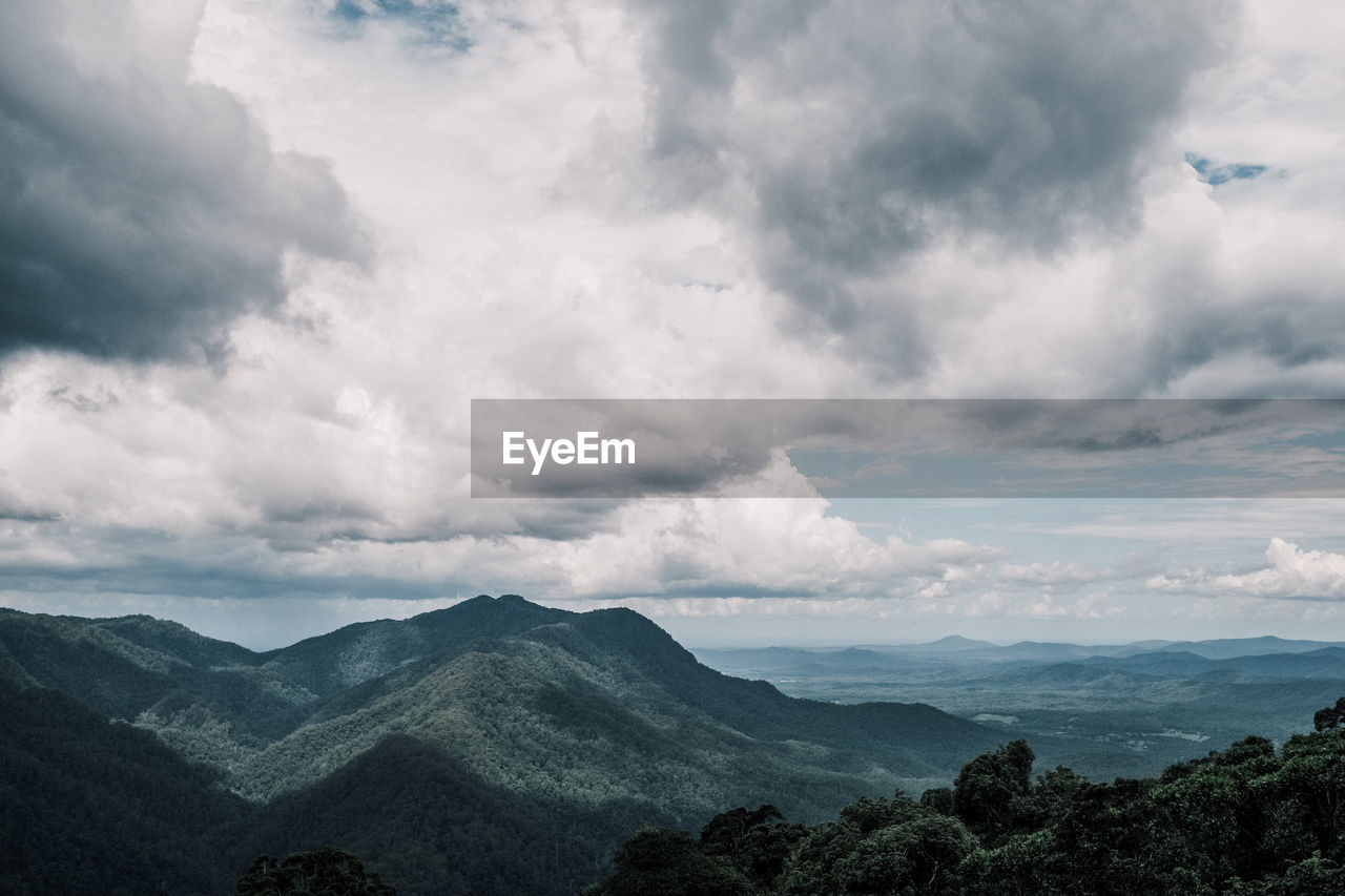scenic view of mountains against cloudy sky