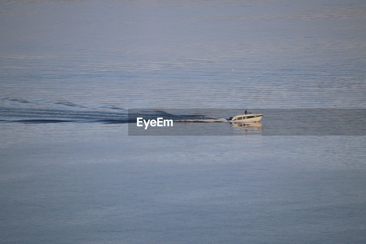 HIGH ANGLE VIEW OF SHIP SAILING ON SEA