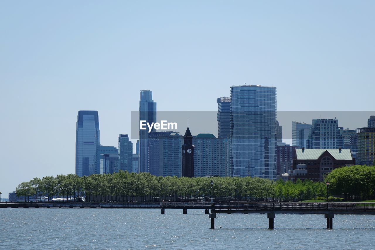 Modern buildings in city against clear sky