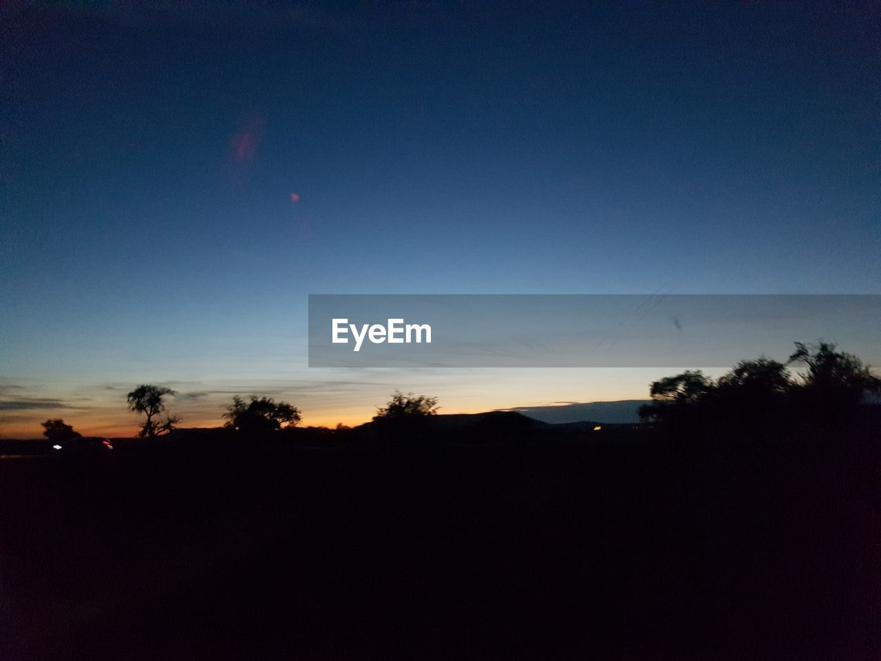 SCENIC VIEW OF SILHOUETTE TREES AGAINST SKY AT SUNSET