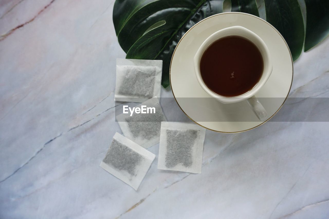 HIGH ANGLE VIEW OF COFFEE CUP ON TABLE AT HOME