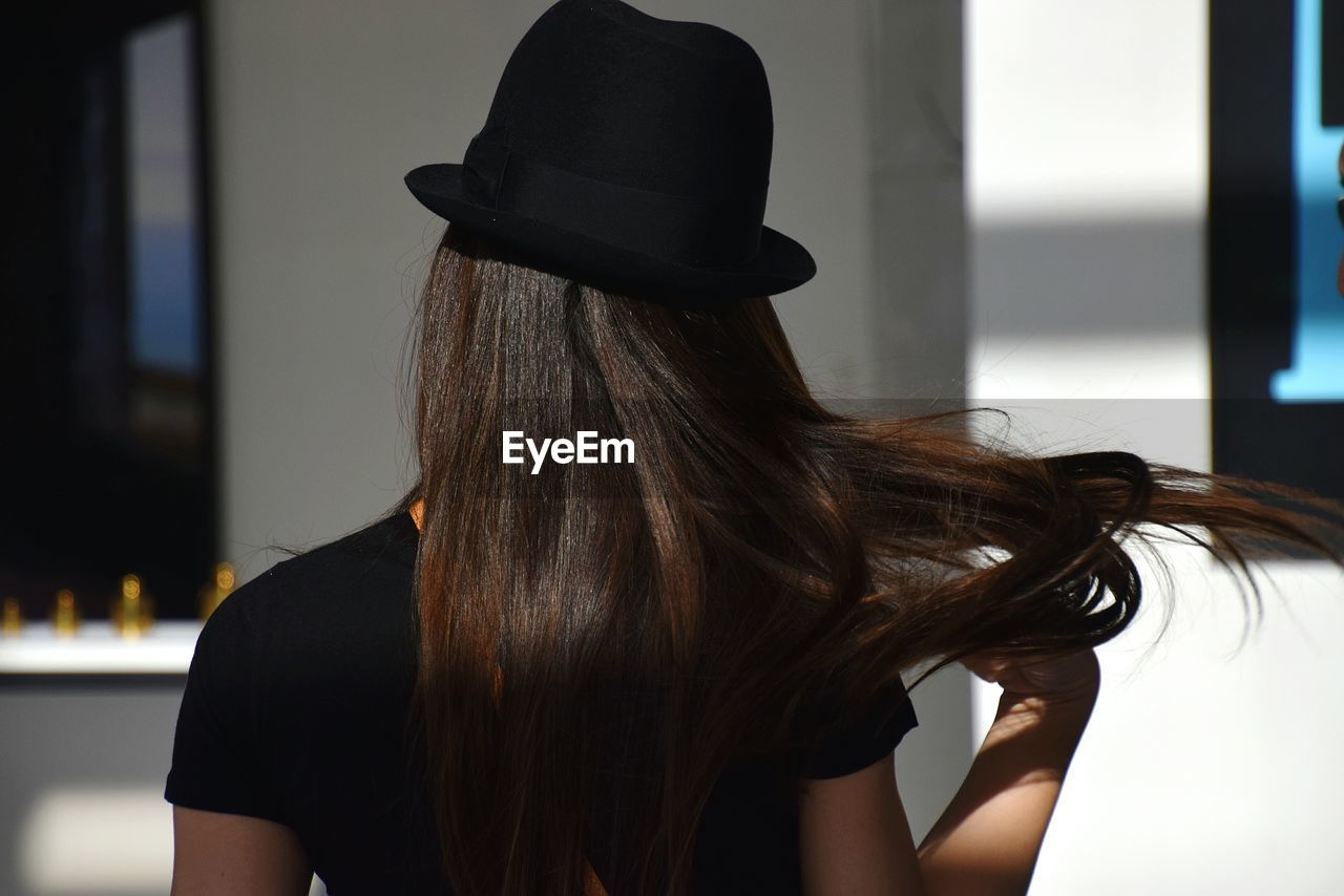 Rear view of woman wearing hat outdoors