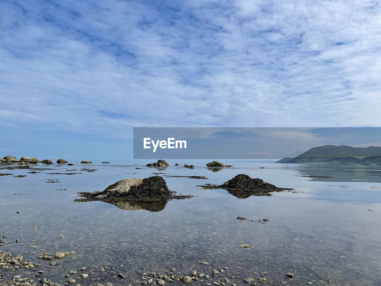 Rocks on beach against sky