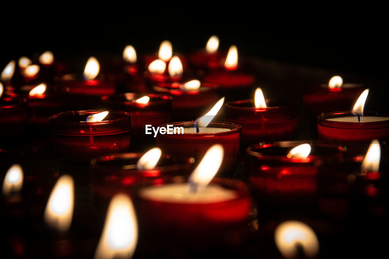 candle, burning, flame, fire, religion, heat, belief, spirituality, place of worship, illuminated, selective focus, no people, close-up, indoors, nature, large group of objects, red, in a row, light, dark, darkness, celebration, tradition, glowing, lighting, building, architecture