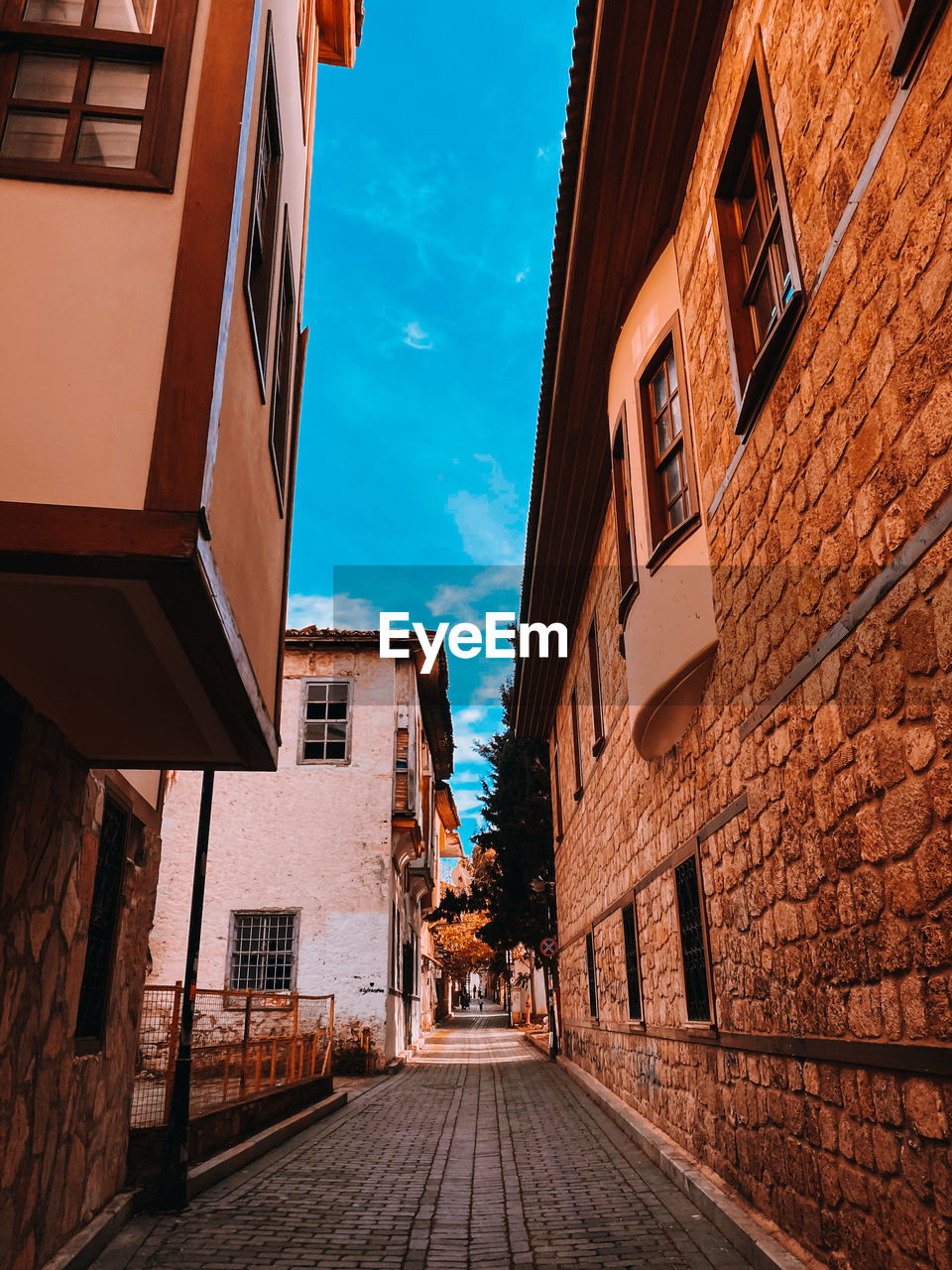 Street amidst buildings in city against sky