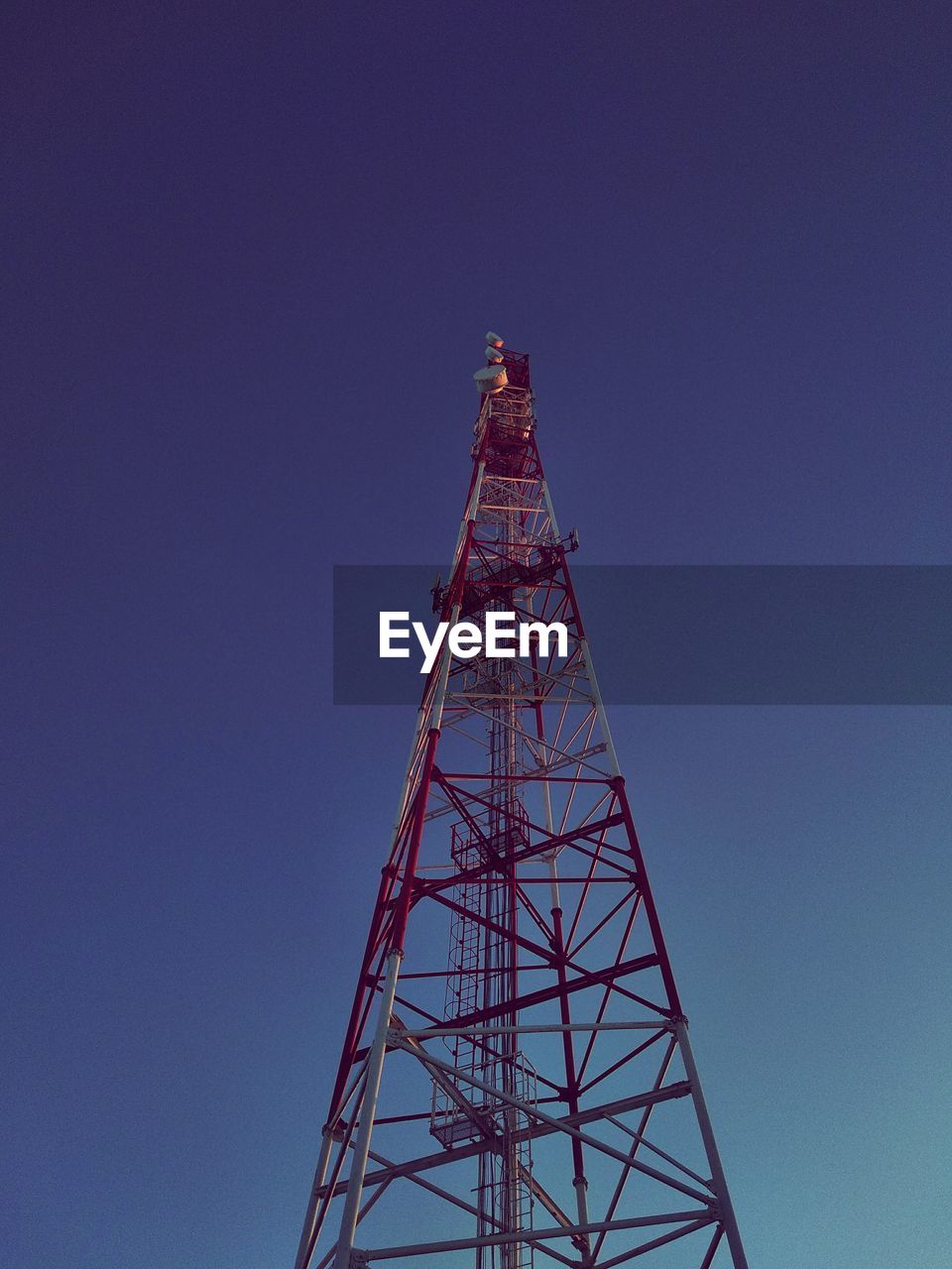 Low angle view of communications tower against sky