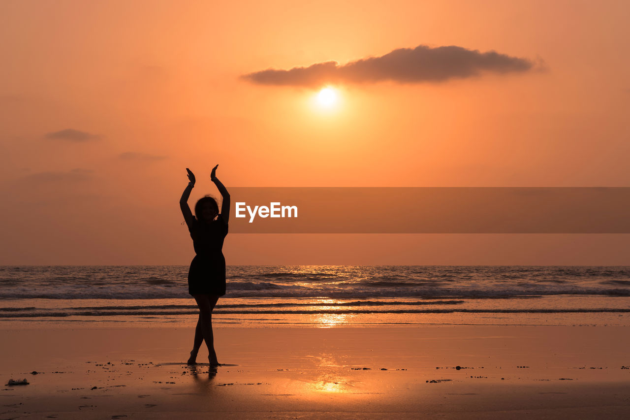 Silhouette of woman standing on beach