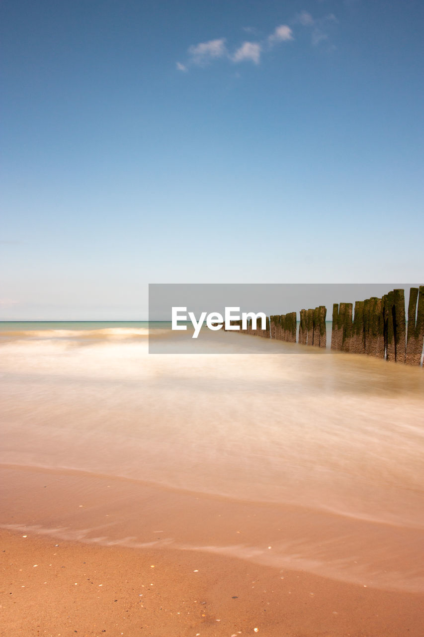 Scenic view of beach against clear sky