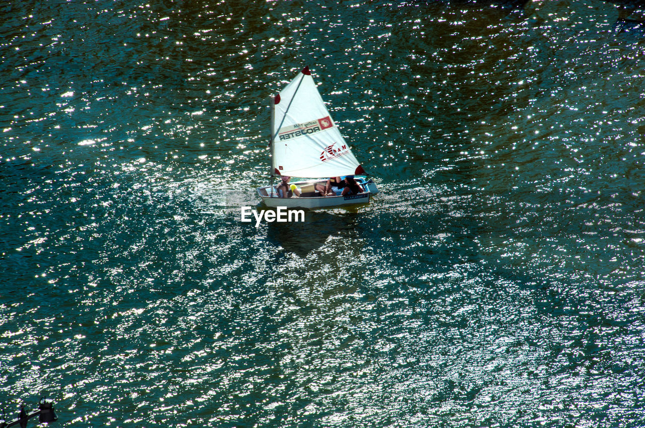 HIGH ANGLE VIEW OF WOMAN IN BOAT SAILING IN SEA