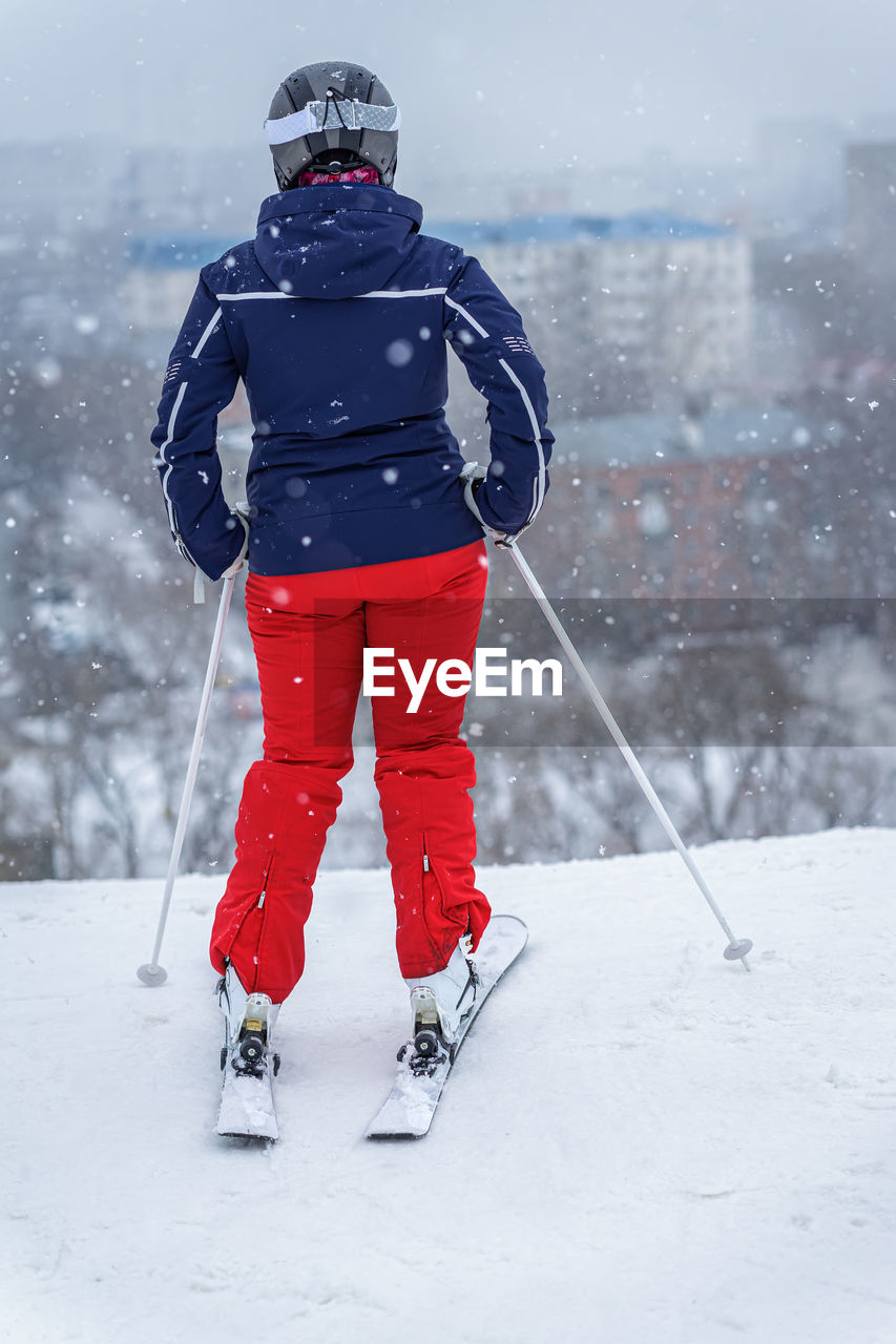 REAR VIEW OF MAN WITH UMBRELLA