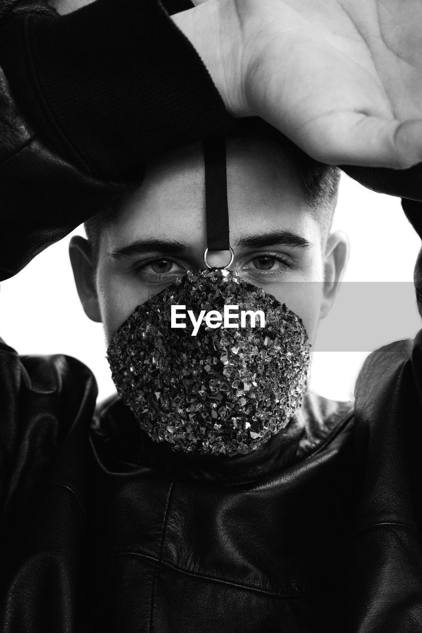 Close-up portrait of young man wearing mask