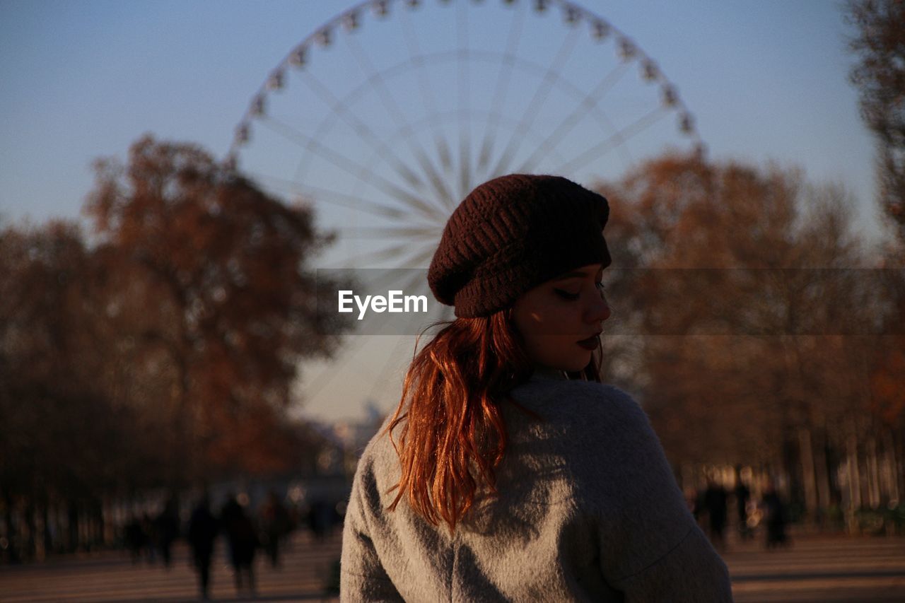 Woman looking over shoulder in city