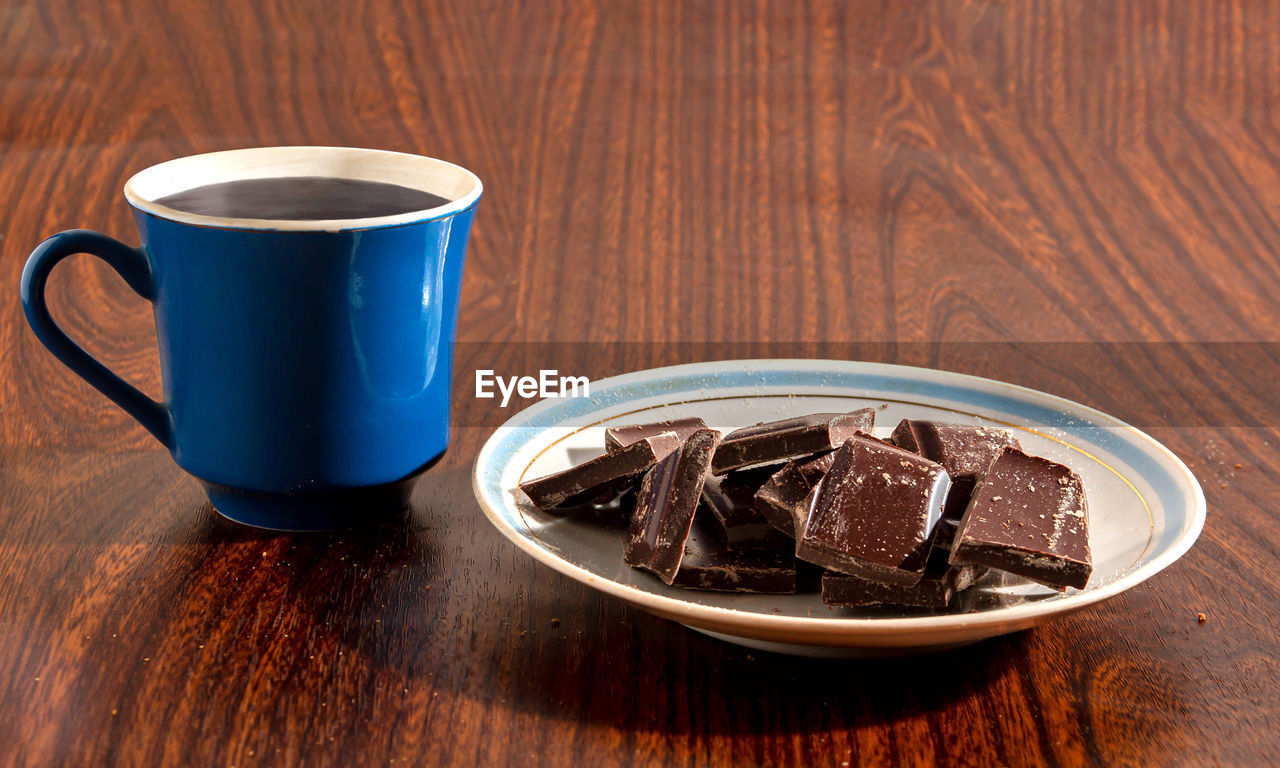 Pieces of chocolate and a cup of coffee