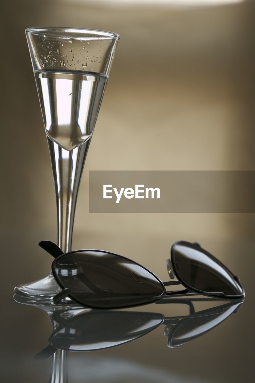 Close-up of drink with sunglasses on table