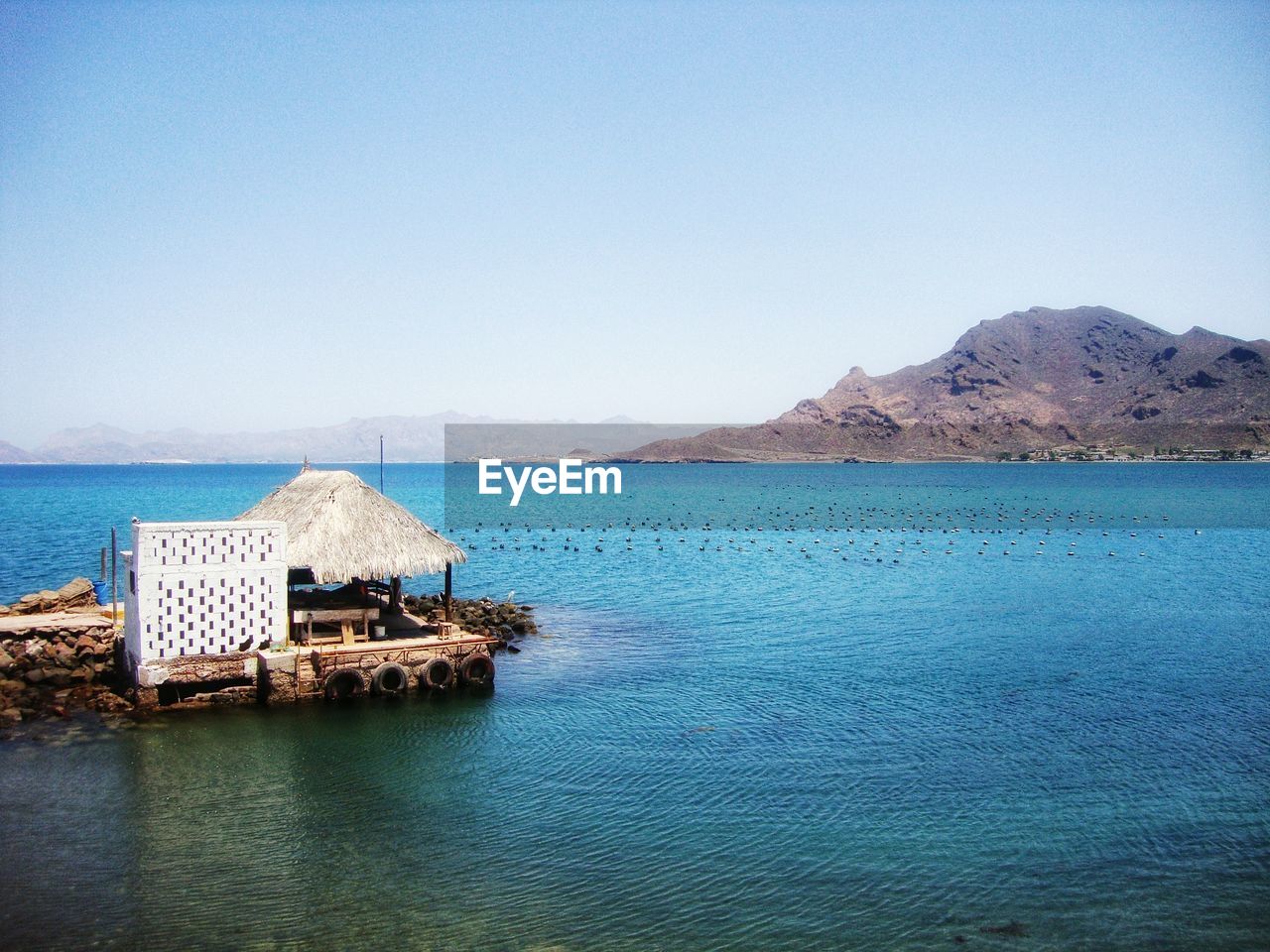 Scenic view of sea against clear blue sky