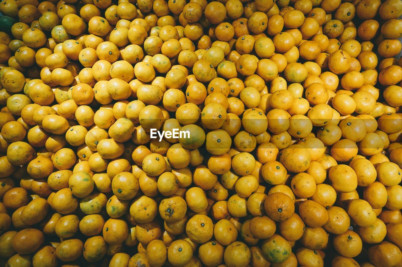 Full frame shot of orange fruits at market for sale