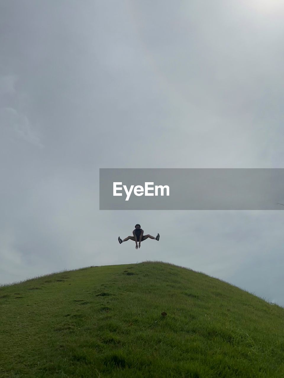 low angle view of airplane flying over field against sky