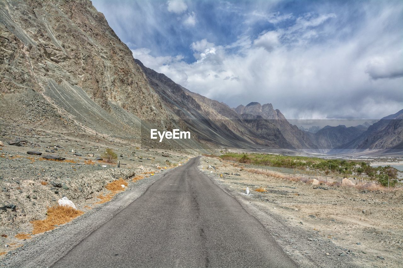 Road amidst mountains against sky