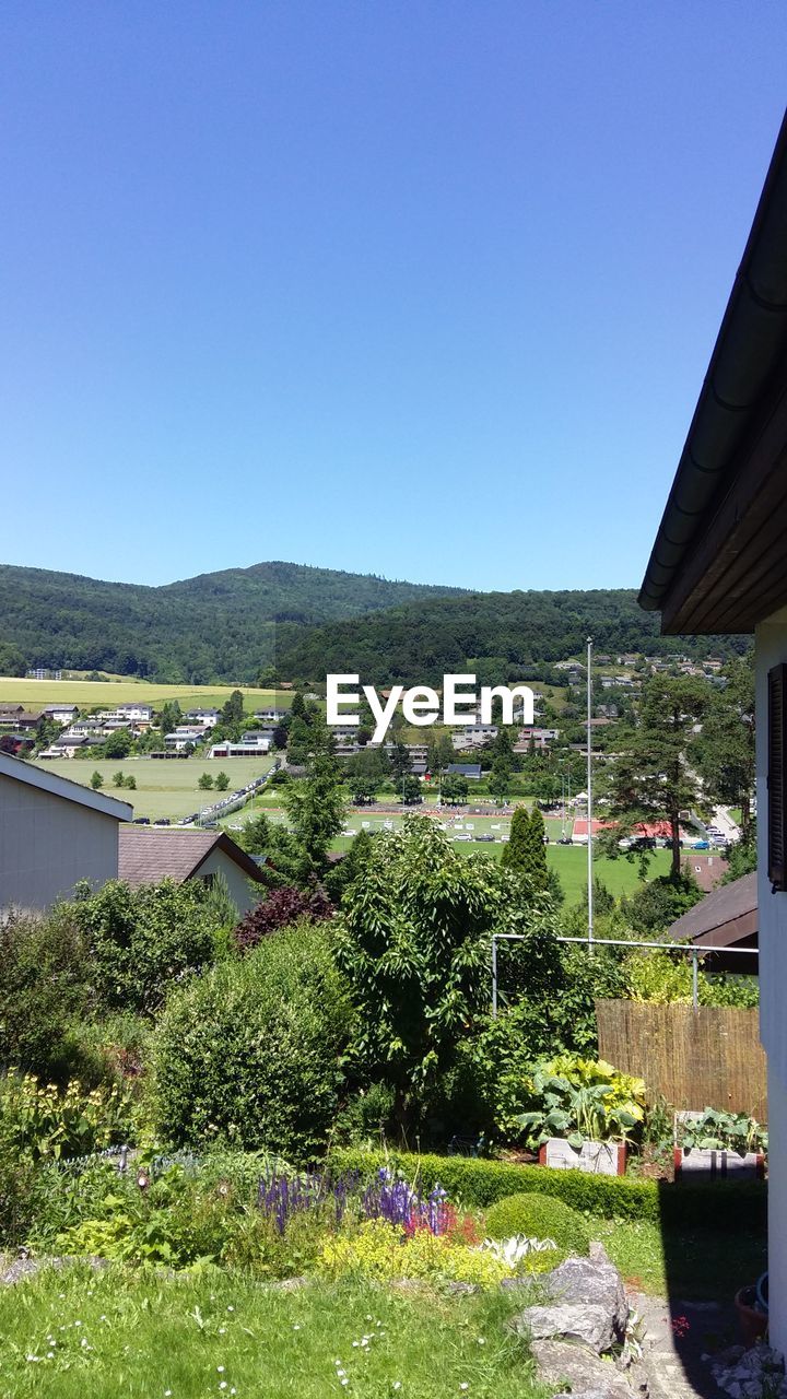 HOUSES AGAINST CLEAR BLUE SKY