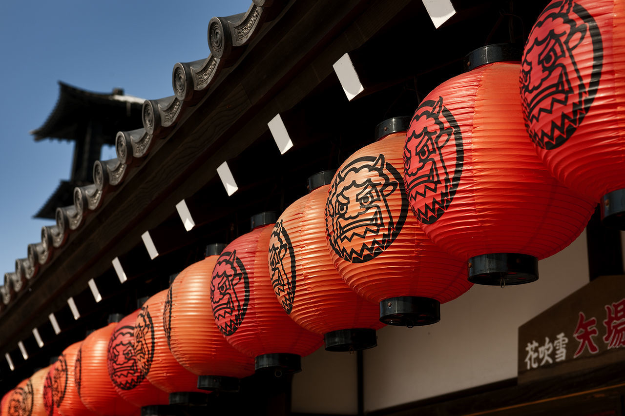 LOW ANGLE VIEW OF LANTERN HANGING AGAINST BUILDING