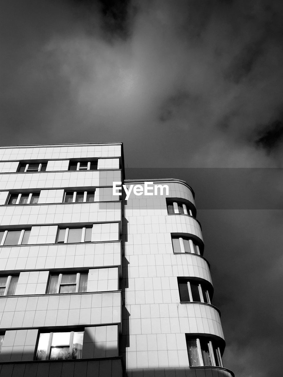 Low angle view of building against cloudy sky