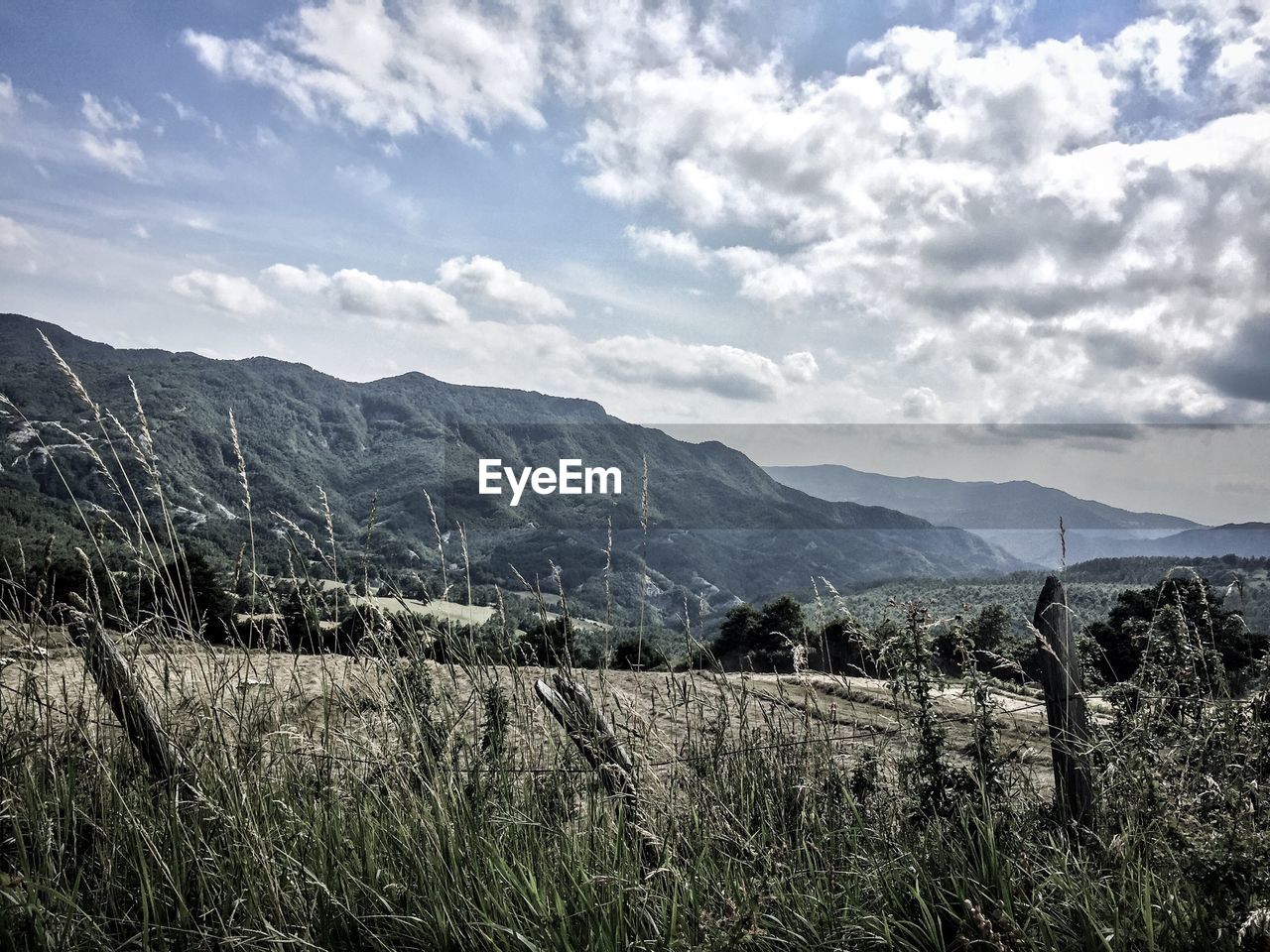 Scenic view of mountains against cloudy sky