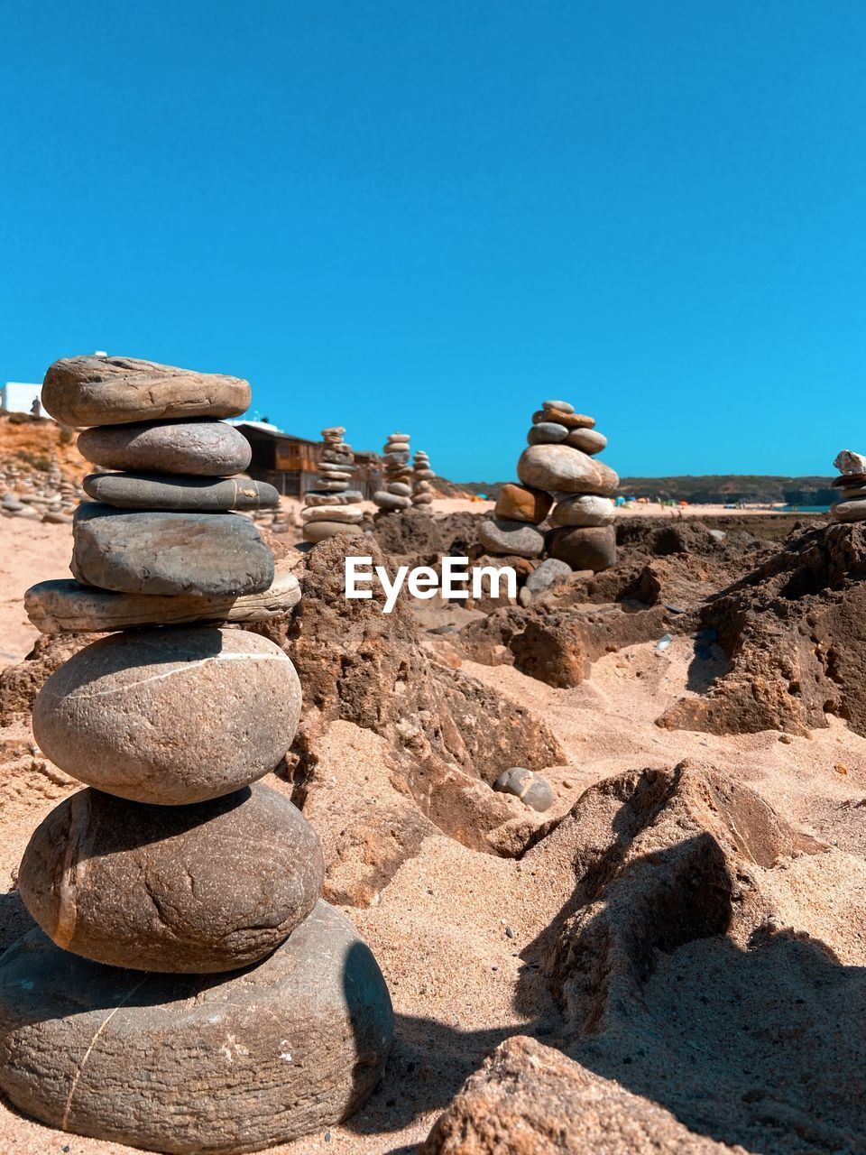 STACK OF STONES ON ROCK AGAINST SKY