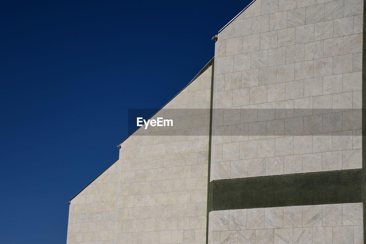 Low angle view of building against blue sky