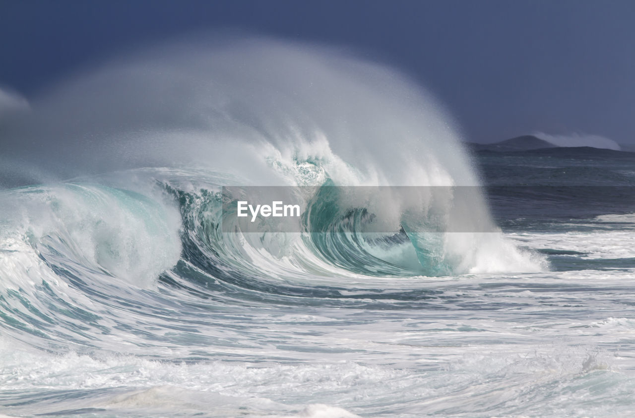 View of waves in sea against sky