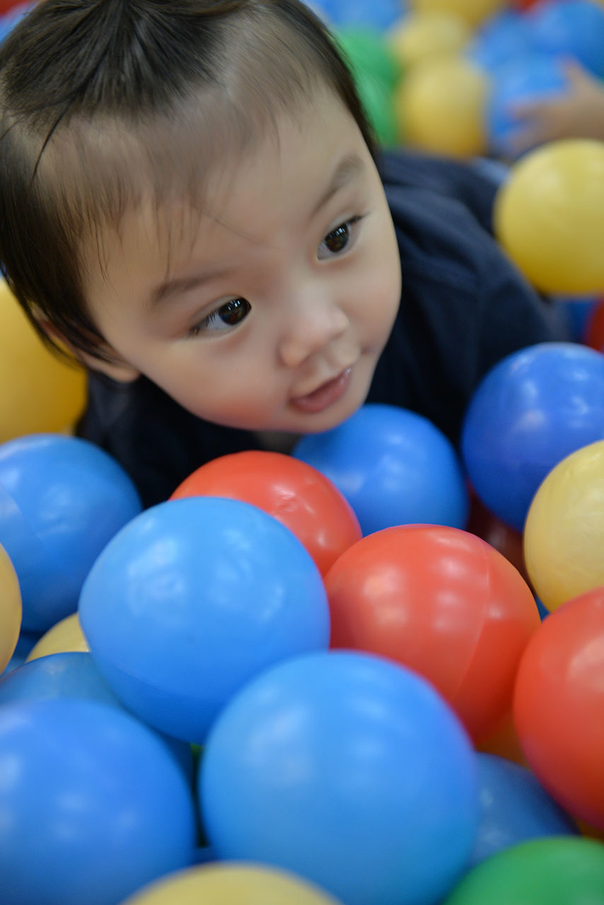 Close-up of baby playing in ball pool