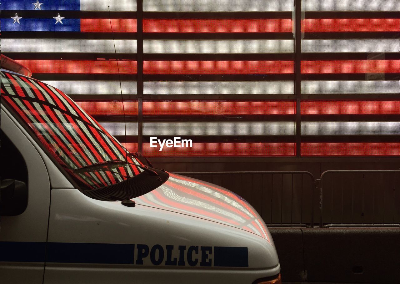 Police vehicle on street against digital american flag