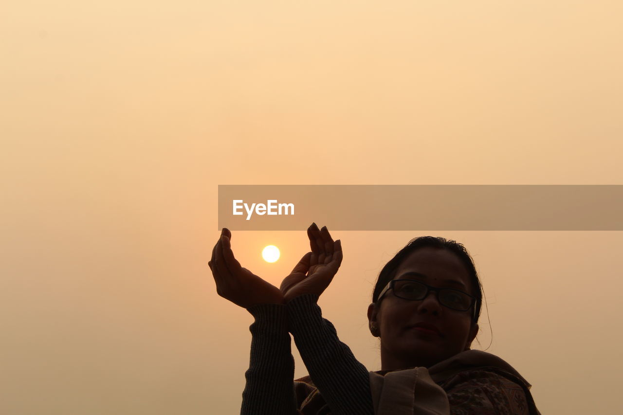 Close-up of woman during sunrise