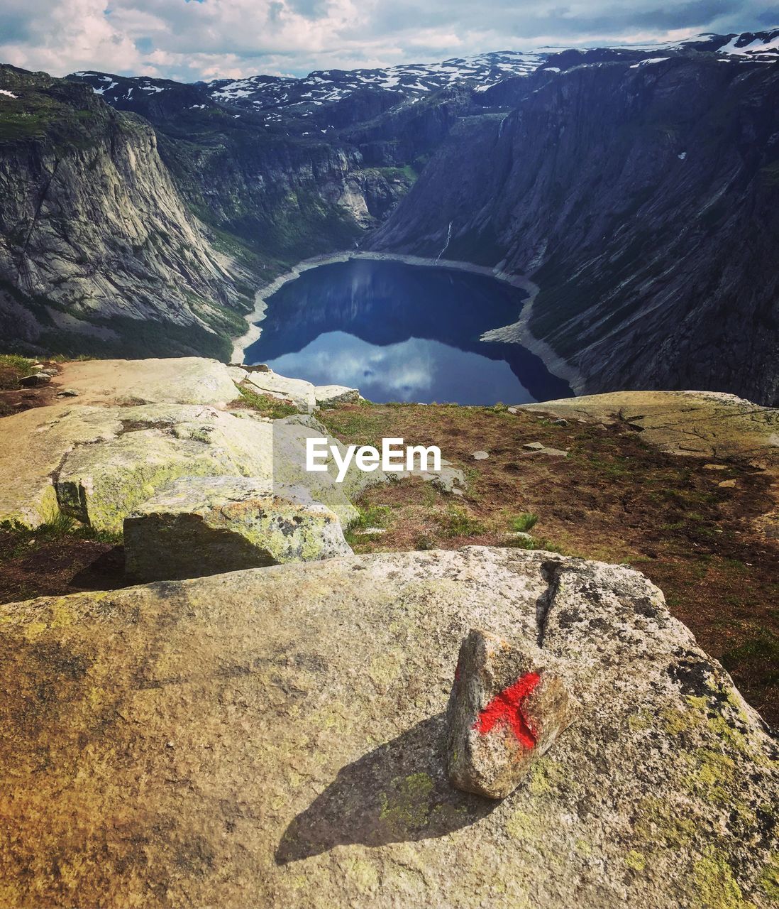 Aerial view of river amidst rocky mountains on sunny day