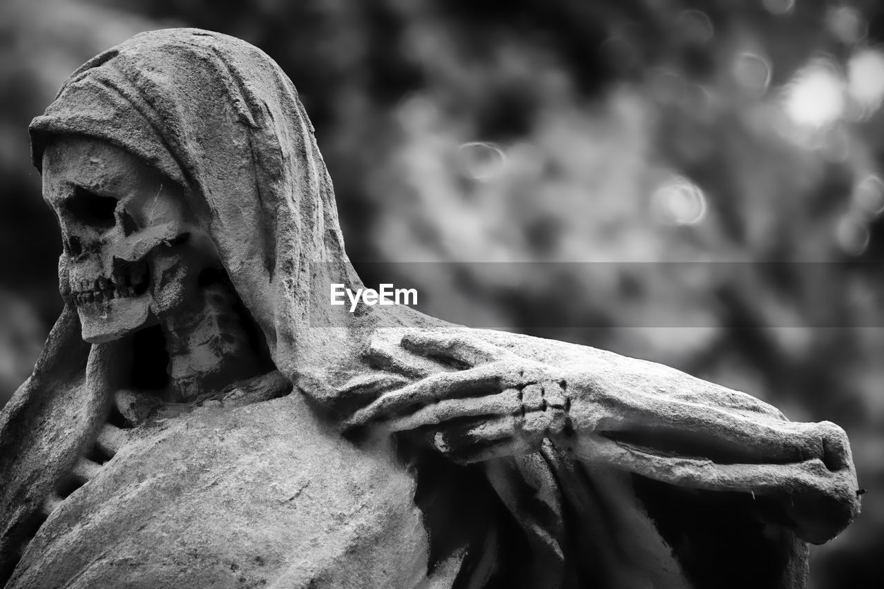 Close-up of angel statue in cemetery