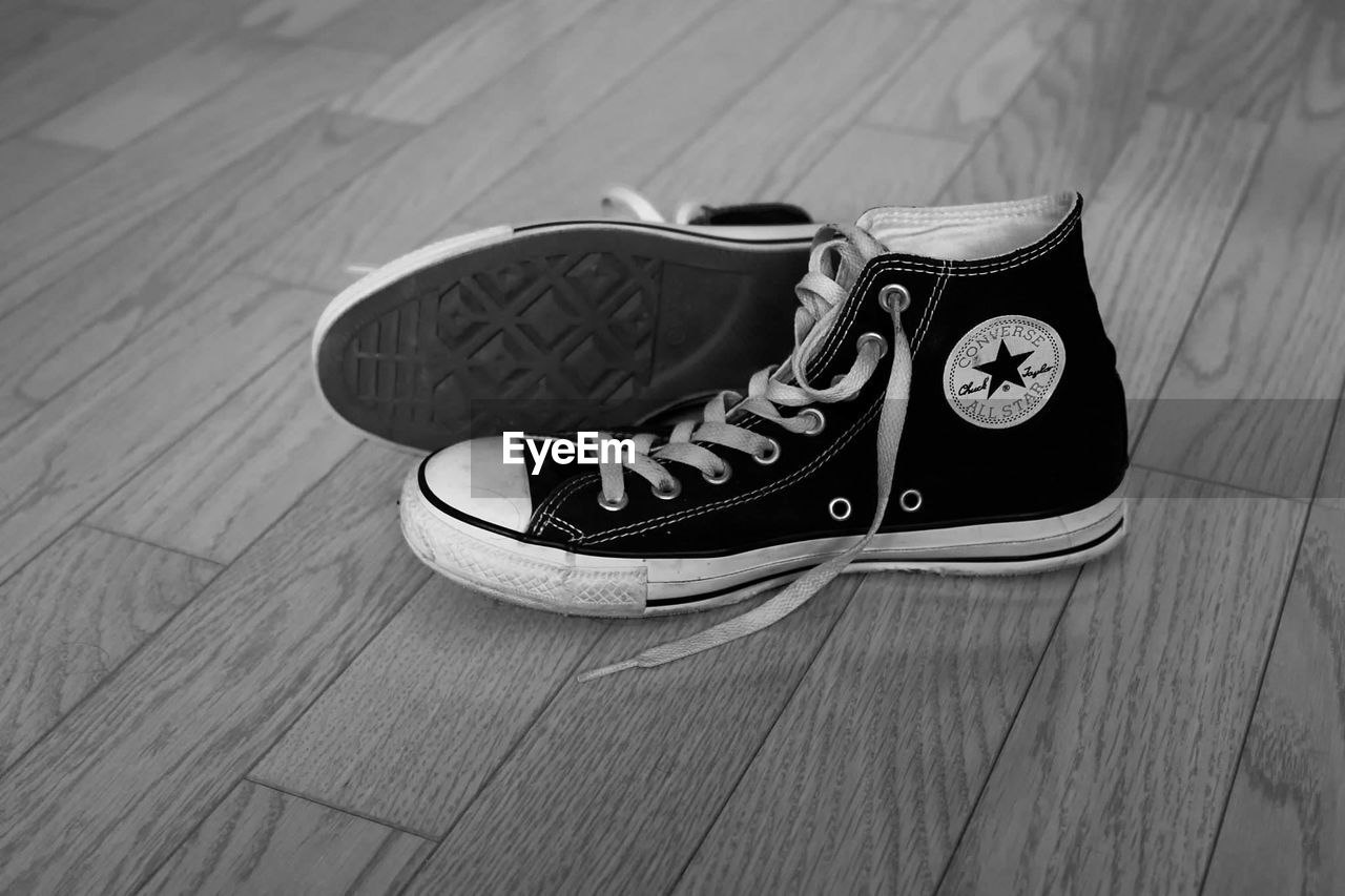 HIGH ANGLE VIEW OF SHOES ON WOODEN TABLE