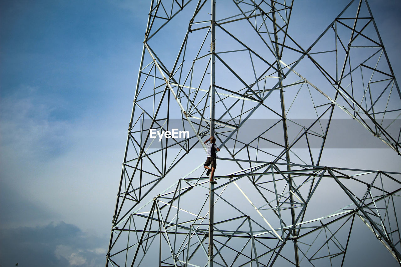 LOW ANGLE VIEW OF PERSON AGAINST SKY