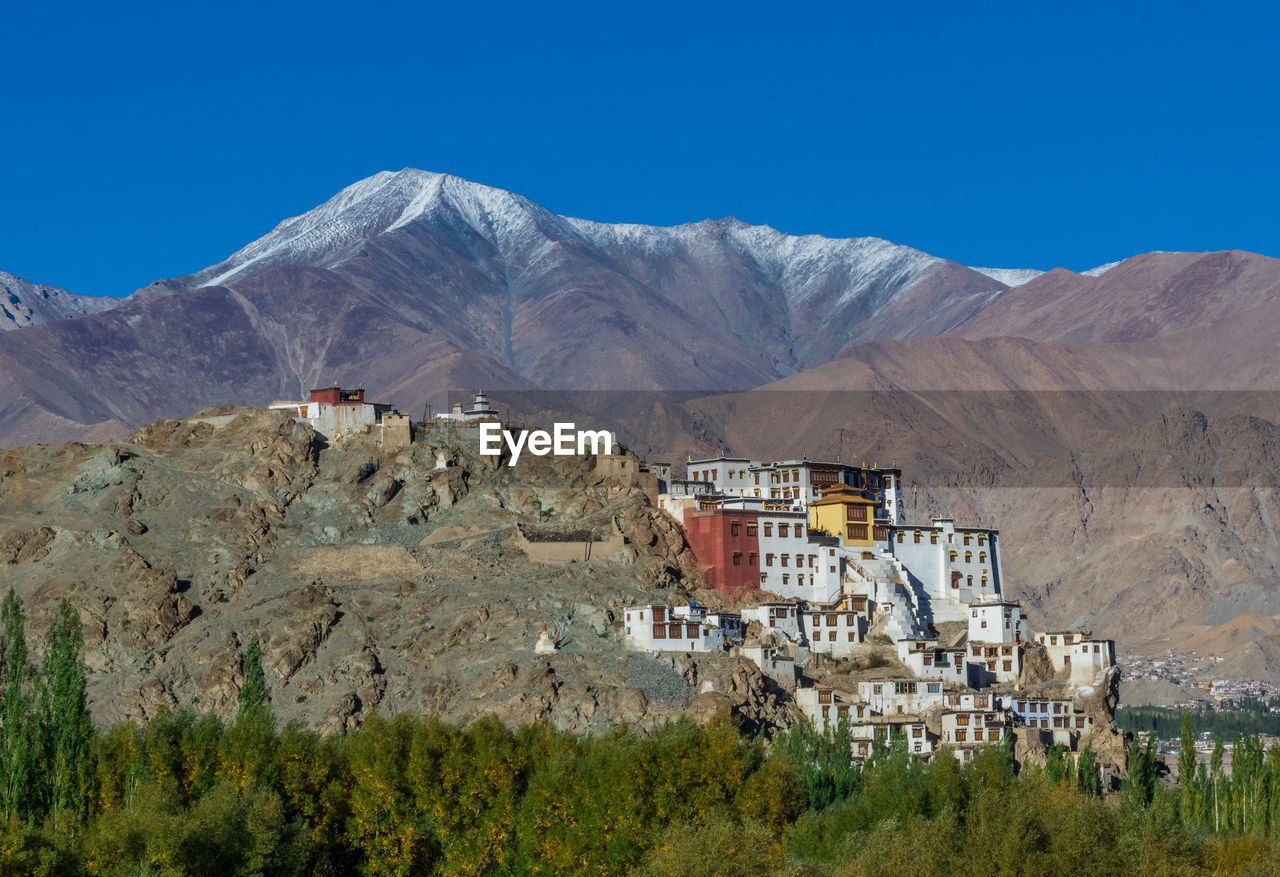 Scenic view of mountain range against blue sky