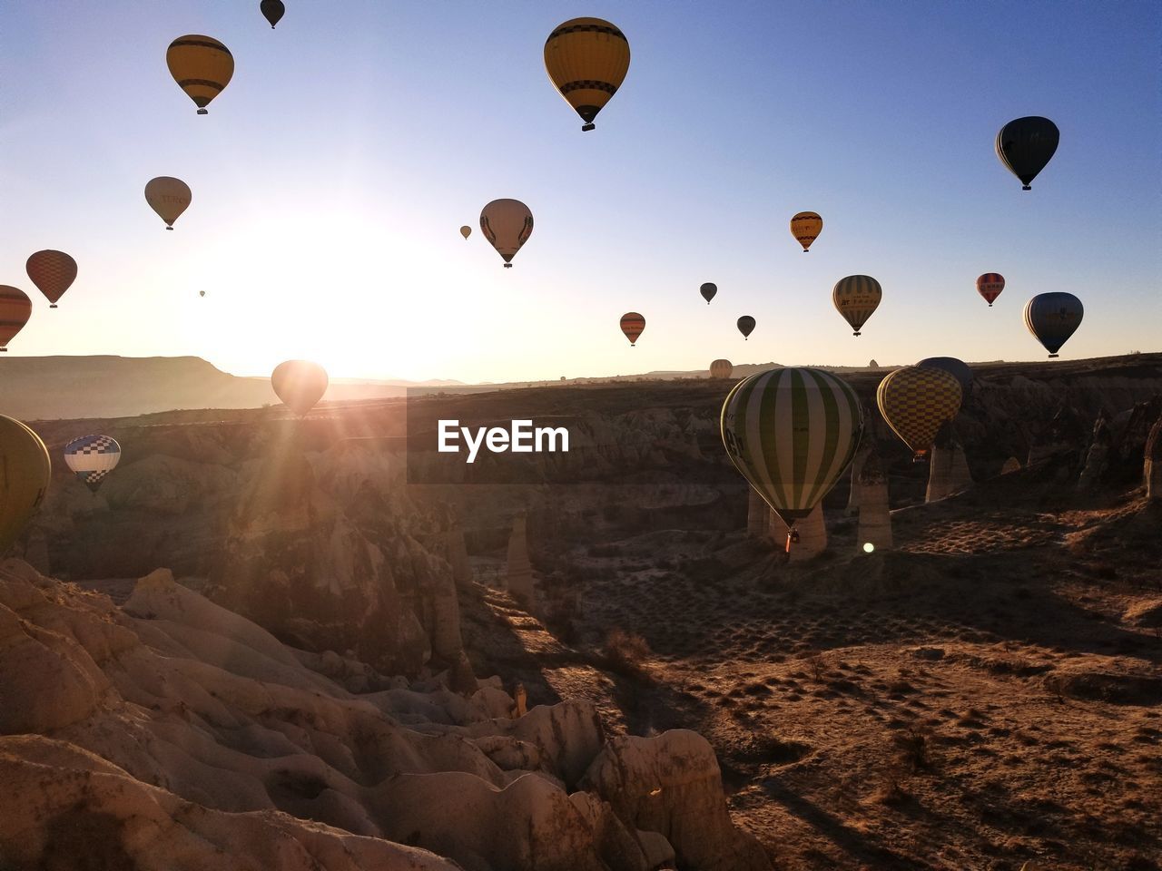 HOT AIR BALLOONS FLYING OVER LANDSCAPE