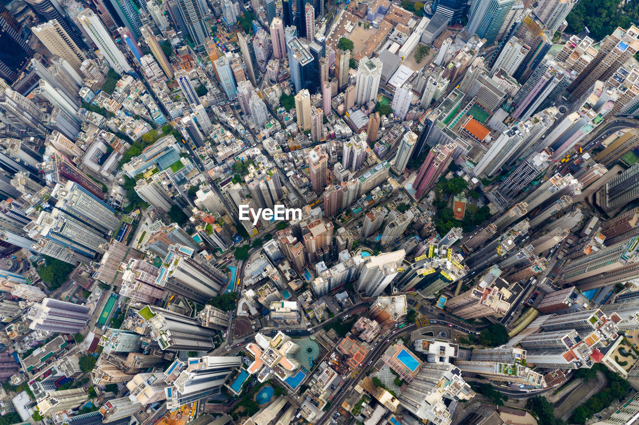 HIGH ANGLE VIEW OF CROWD ON STREET BY BUILDINGS