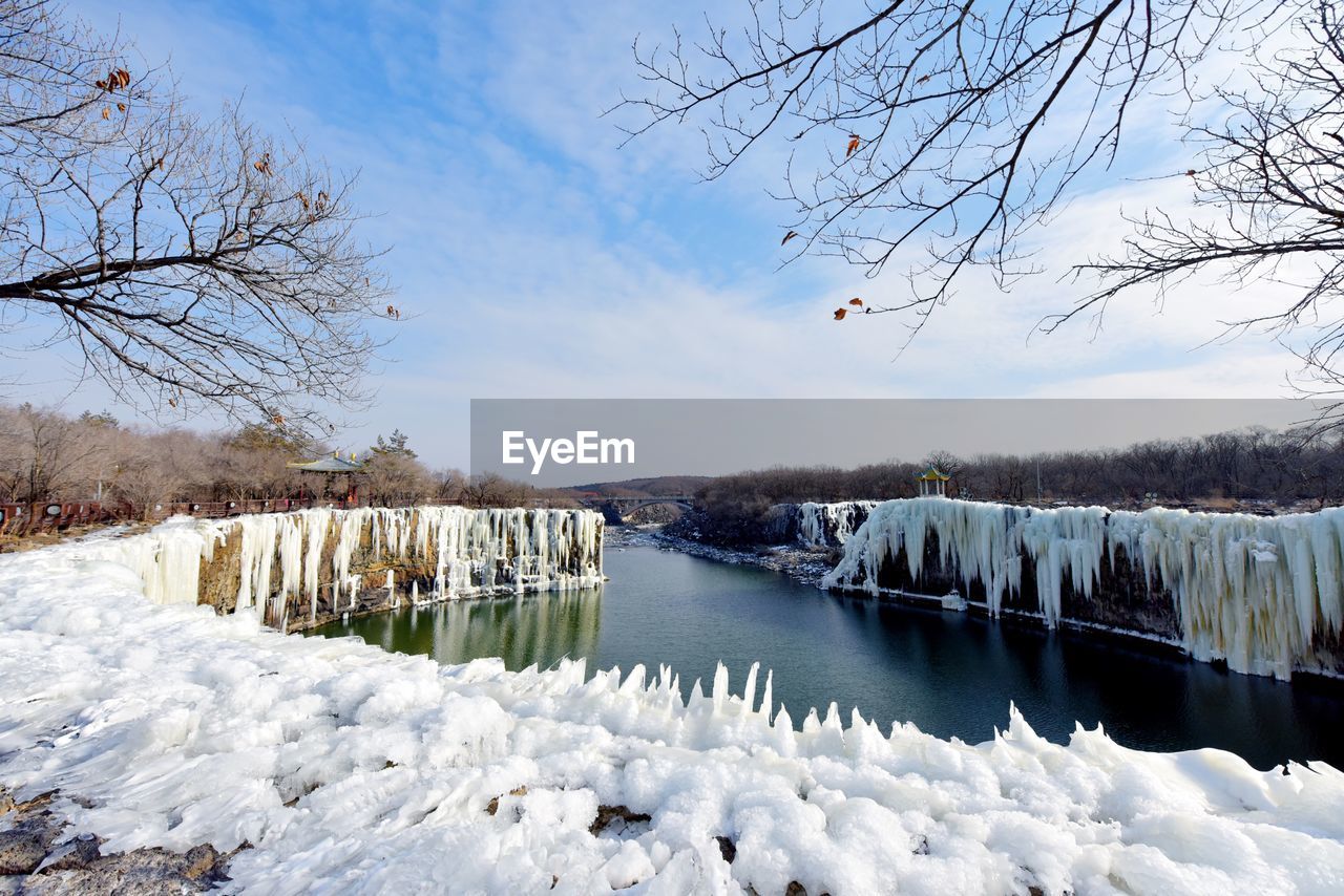 Scenic view of frozen lake against sky during winter